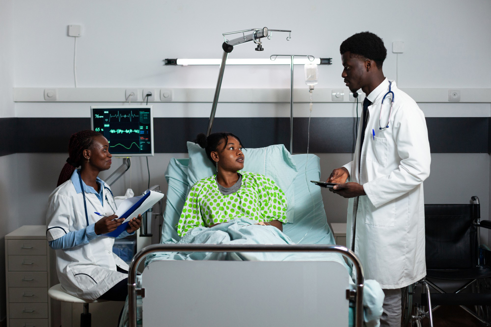 afro doctors consulting young adult hospital ward